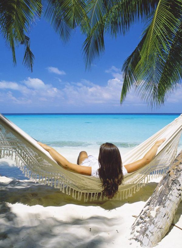 Woman-sitting-in-hammock-on-beach-Maldives-Indian-Ocean-Asia